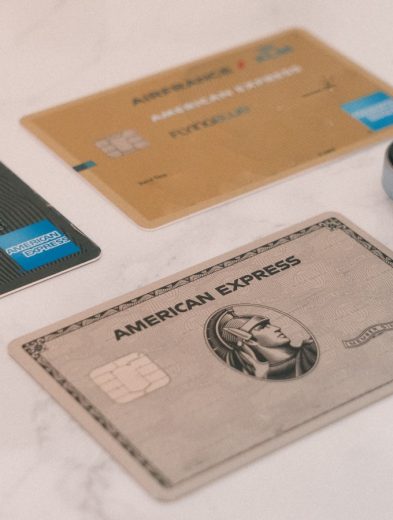 a group of credit cards sitting next to a cell phone