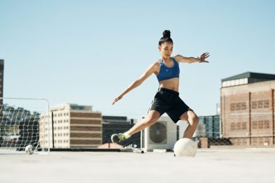 soccer player woman and soccer ball kick in fitness 76047129 Large